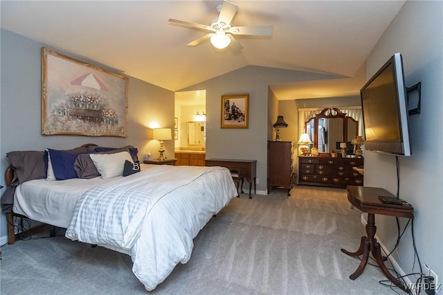 carpeted bedroom featuring vaulted ceiling, baseboards, a ceiling fan, and ensuite bathroom