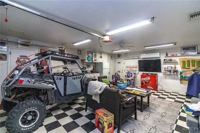 garage featuring a ceiling fan, a wall unit AC, visible vents, and a garage door opener