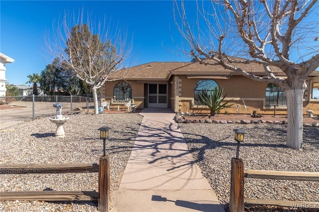 ranch-style house featuring a patio area, fence, and stucco siding