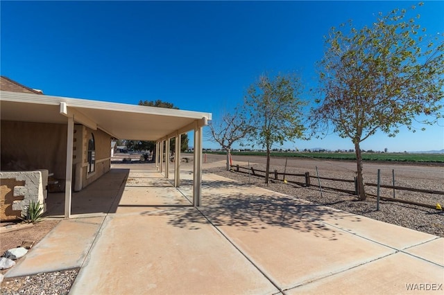 view of patio with an attached carport and driveway