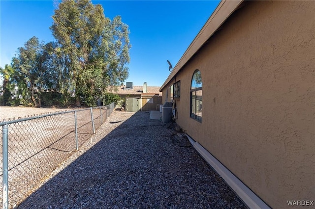 view of home's exterior with fence and stucco siding