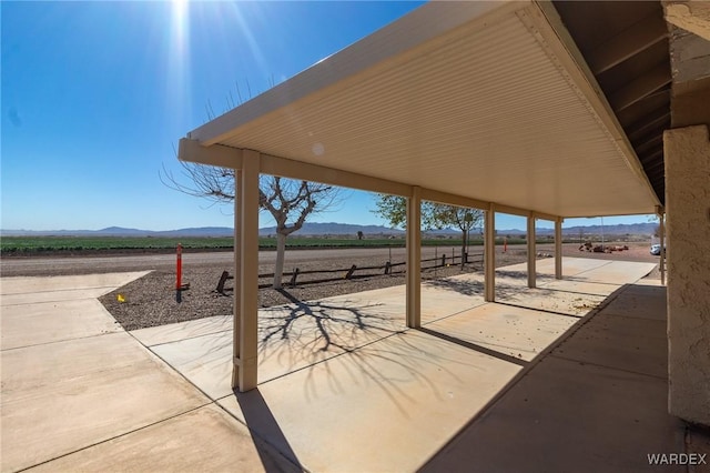 view of patio / terrace featuring a rural view and a mountain view