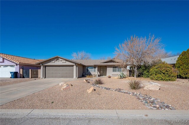 single story home featuring a garage, driveway, and stucco siding