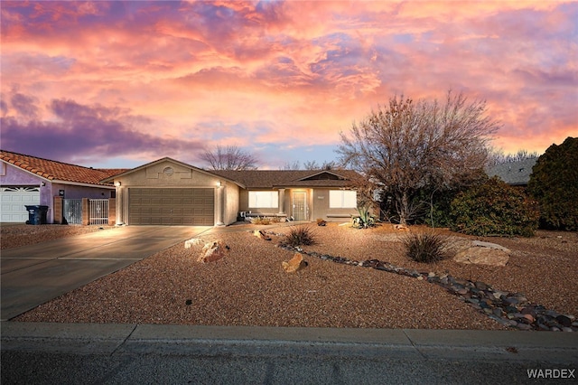 view of front facade featuring a garage, driveway, and stucco siding