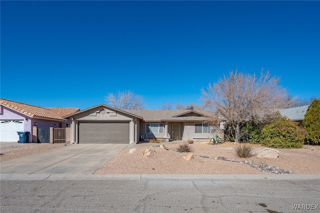 ranch-style home with a garage, concrete driveway, and stucco siding