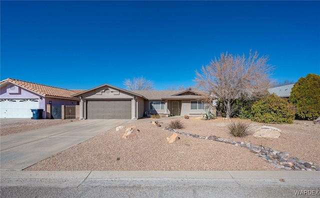 single story home with a garage, concrete driveway, and stucco siding