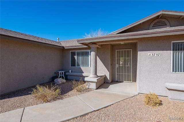 entrance to property with stucco siding