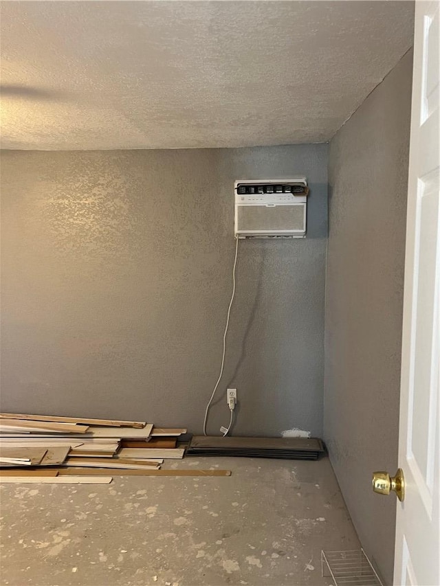 2495 E Devlin Ave, Kingman, AZ 86409 - detailed view of unfinished concrete floors, a textured ceiling, and an AC wall unit