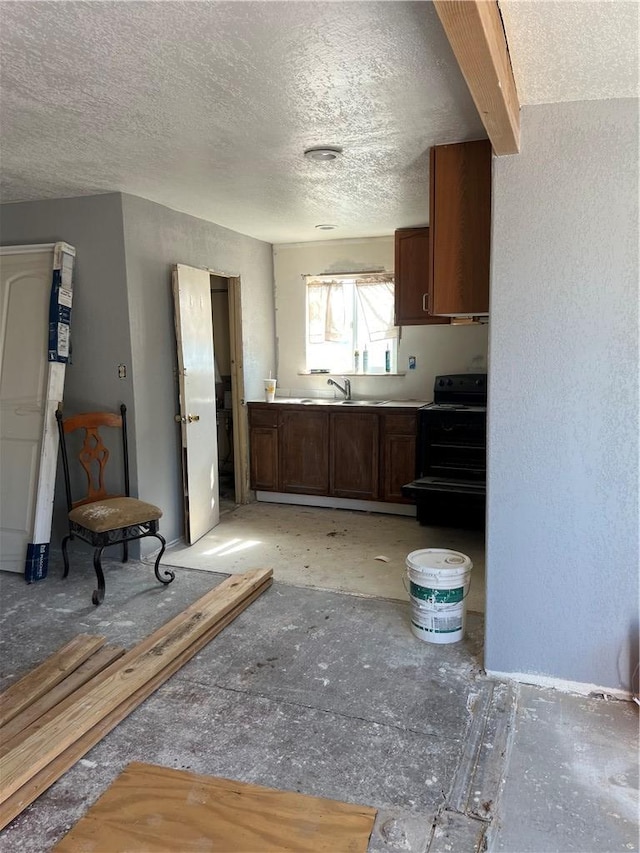 2495 E Devlin Ave, Kingman, AZ 86409 - kitchen featuring a textured ceiling, a sink, and electric range