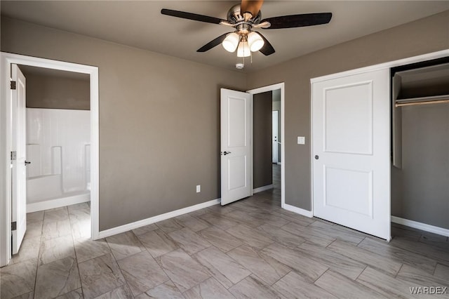 unfurnished bedroom featuring a ceiling fan, ensuite bath, baseboards, and a closet