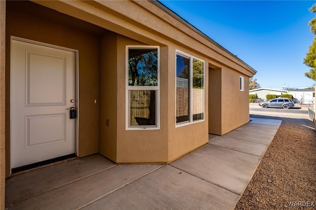 exterior space featuring a patio area and stucco siding