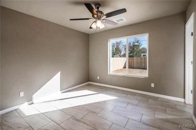 unfurnished room with ceiling fan, visible vents, and baseboards