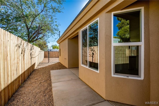 view of home's exterior with a fenced backyard, a patio, and stucco siding