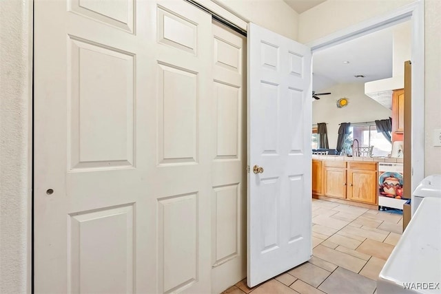 hallway featuring washer / clothes dryer and a sink