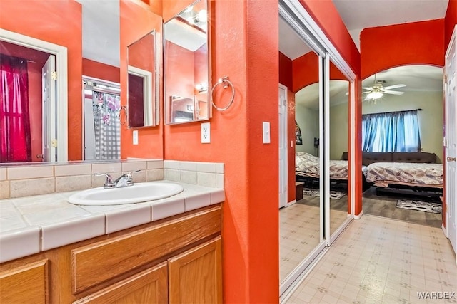 ensuite bathroom with tile patterned floors, vanity, ensuite bathroom, and ceiling fan