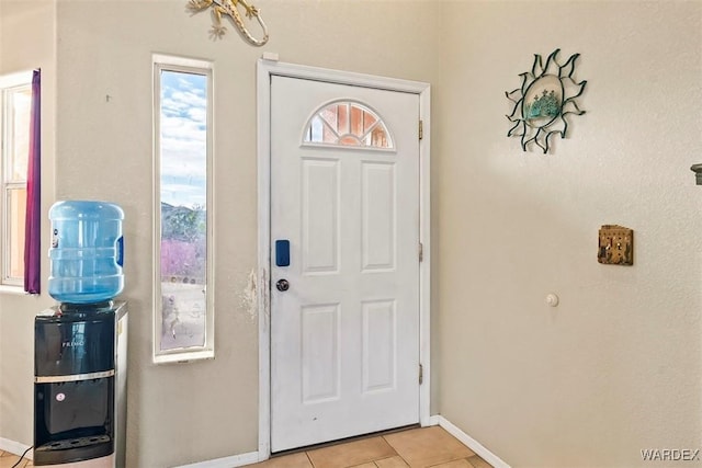 entryway featuring light tile patterned floors and baseboards