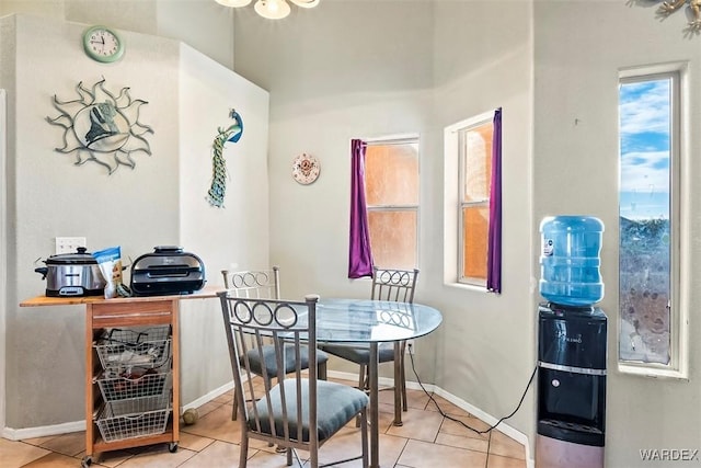 tiled dining space featuring baseboards