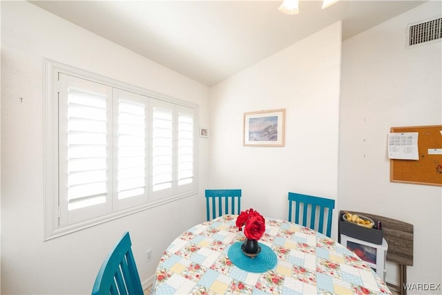 dining room featuring visible vents and lofted ceiling