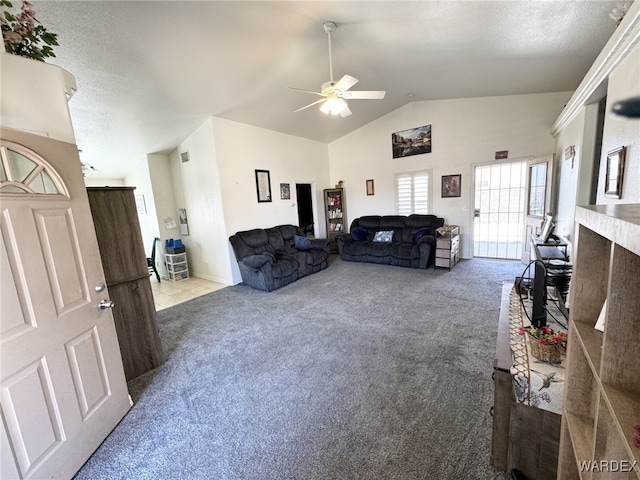 carpeted living area with lofted ceiling, a textured ceiling, and a ceiling fan