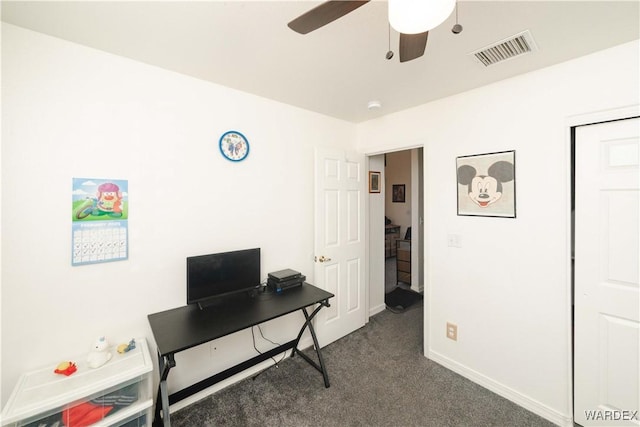 office area with a ceiling fan, baseboards, visible vents, and dark colored carpet