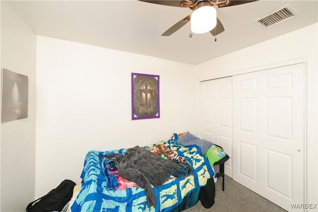 bedroom featuring carpet, visible vents, a closet, and ceiling fan