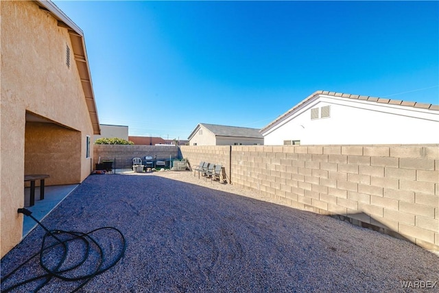 view of yard with a patio and a fenced backyard