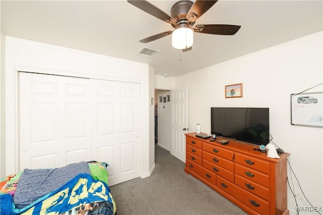 carpeted bedroom featuring visible vents, a closet, and ceiling fan