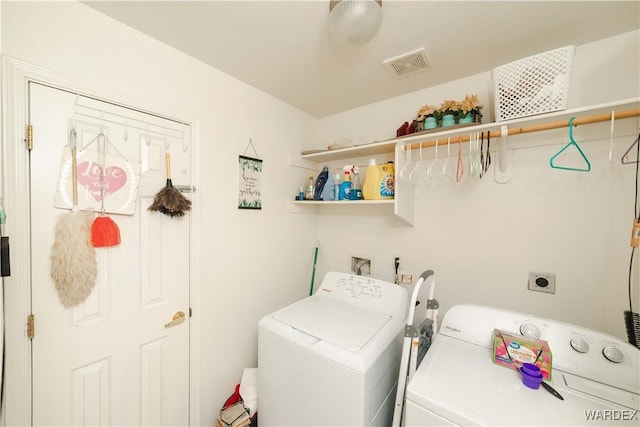 washroom featuring washer and clothes dryer, laundry area, and visible vents