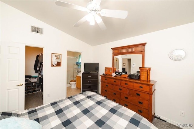 bedroom featuring vaulted ceiling, a spacious closet, light colored carpet, and visible vents