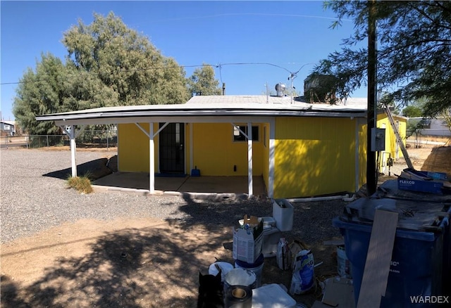 rear view of property featuring fence