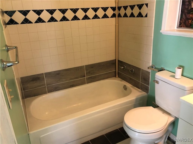 bathroom with shower / bathtub combination, toilet, and tile patterned floors