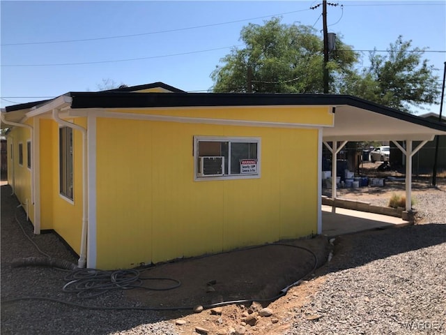 view of side of home with a carport and driveway