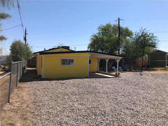 back of property with a fenced backyard and stucco siding