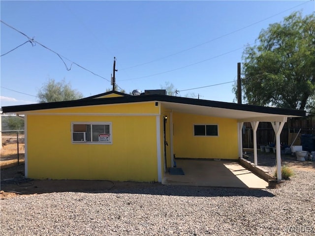 rear view of property featuring stucco siding