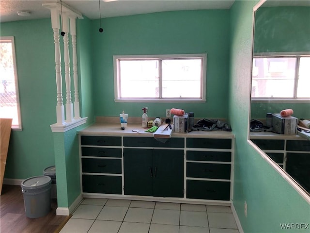 kitchen featuring light countertops, baseboards, and light tile patterned floors