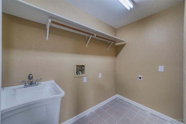 laundry area with washer hookup, a sink, electric dryer hookup, laundry area, and baseboards