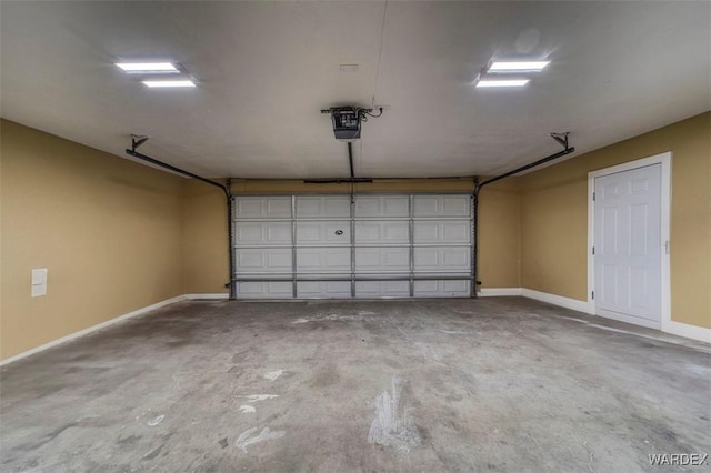 garage with a garage door opener and baseboards