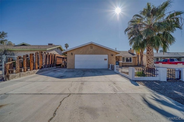 ranch-style home featuring a garage, concrete driveway, a fenced front yard, and stucco siding