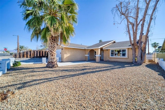 ranch-style home with fence and stucco siding