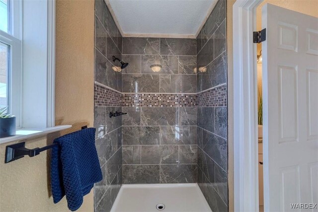 full bath with tiled shower