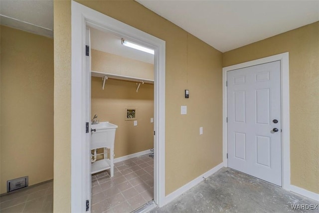 laundry room with laundry area, hookup for a washing machine, and baseboards