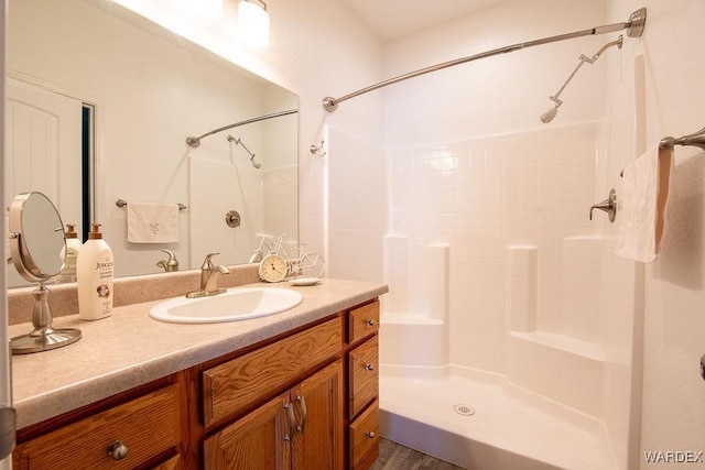 bathroom with a shower and vanity