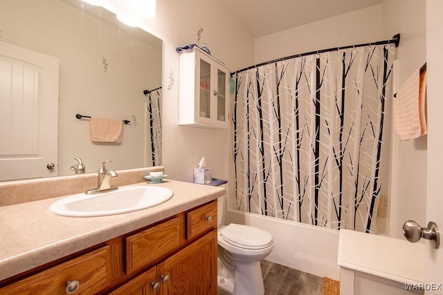 full bathroom with toilet, shower / bathtub combination with curtain, wood finished floors, and vanity