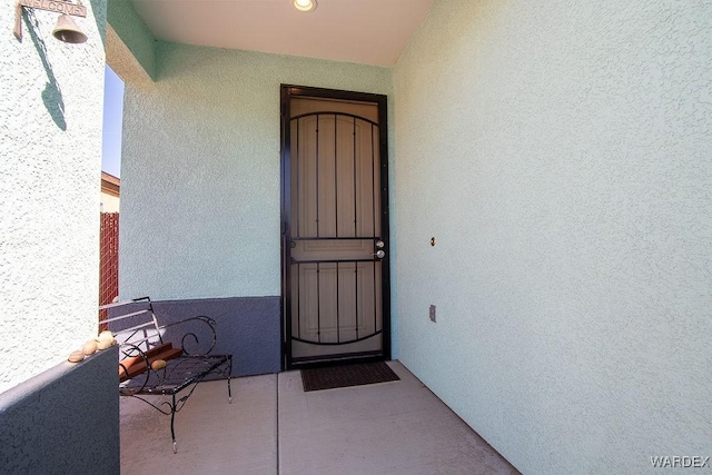 doorway to property with stucco siding