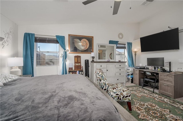 bedroom featuring a ceiling fan, lofted ceiling, and visible vents