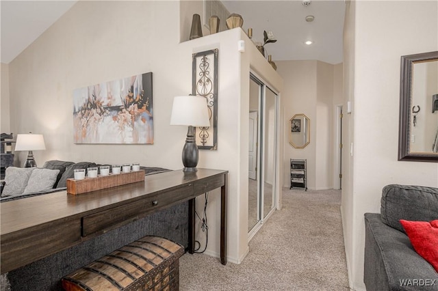 hallway featuring recessed lighting, light carpet, and baseboards