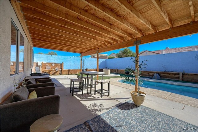 view of patio / terrace with a fenced in pool, outdoor dining area, and a fenced backyard