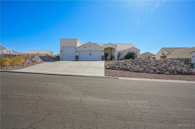 view of front of house featuring concrete driveway and an attached garage