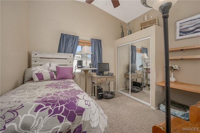 bedroom with a ceiling fan, carpet, a closet, and high vaulted ceiling