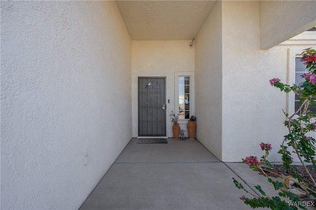 property entrance featuring stucco siding